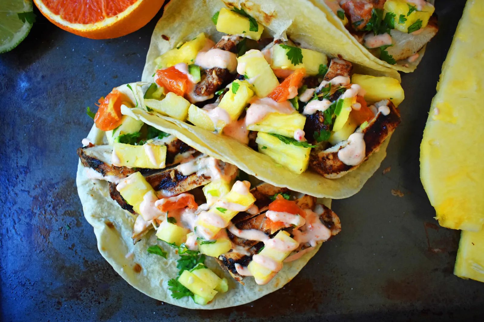 Jamaican Jerk Chicken Tacos. Caribbean spiced citrus grilled chicken filled tacos with pineapple salsa and spicy cream. www.modernhoney.com