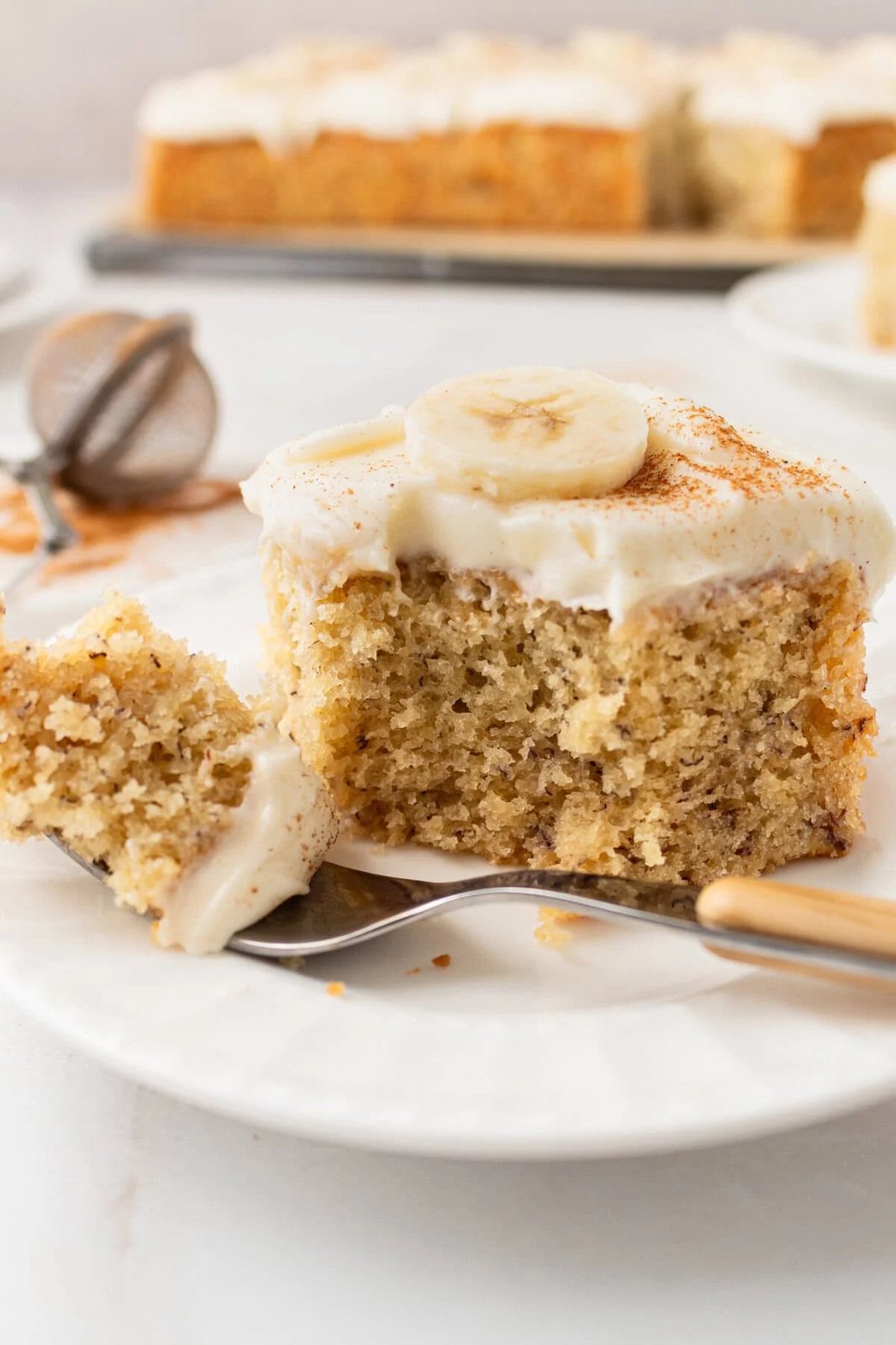 Jeff's BEST Banana Cake Recipe is a moist and tender banana cake with a creamy, sweet, and buttery cream cheese frosting. Some say it is the best banana cake in the world! This moist banana cake with cream cheese frosting is baked in a 9×13 pan and is always a hit!
