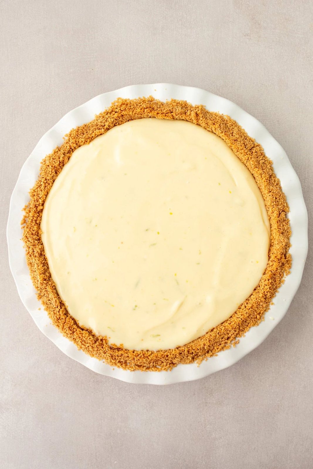 Key Lime Filling in graham cracker crust ready to be baked