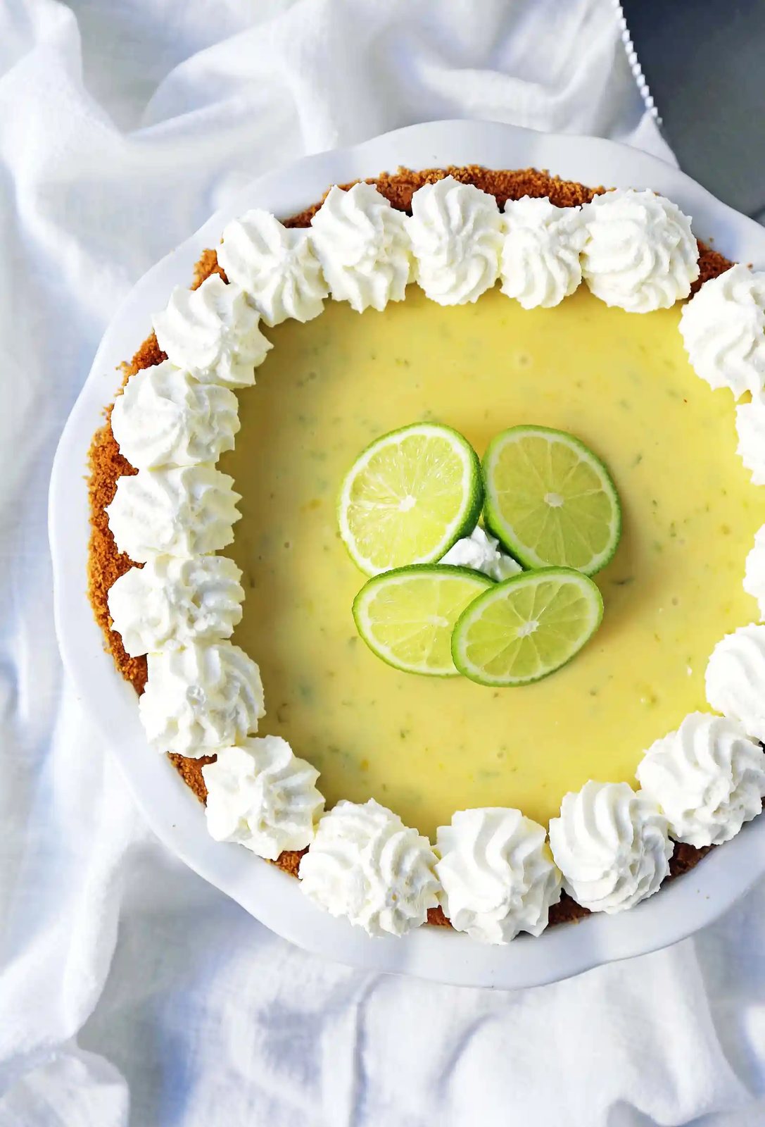 Key Lime Pie. The best creamy key lime pie in a buttery graham cracker crust with fresh sweetened whipped cream. www.modernhoney.com #keylimepie #limepie #pie #easterdesserts