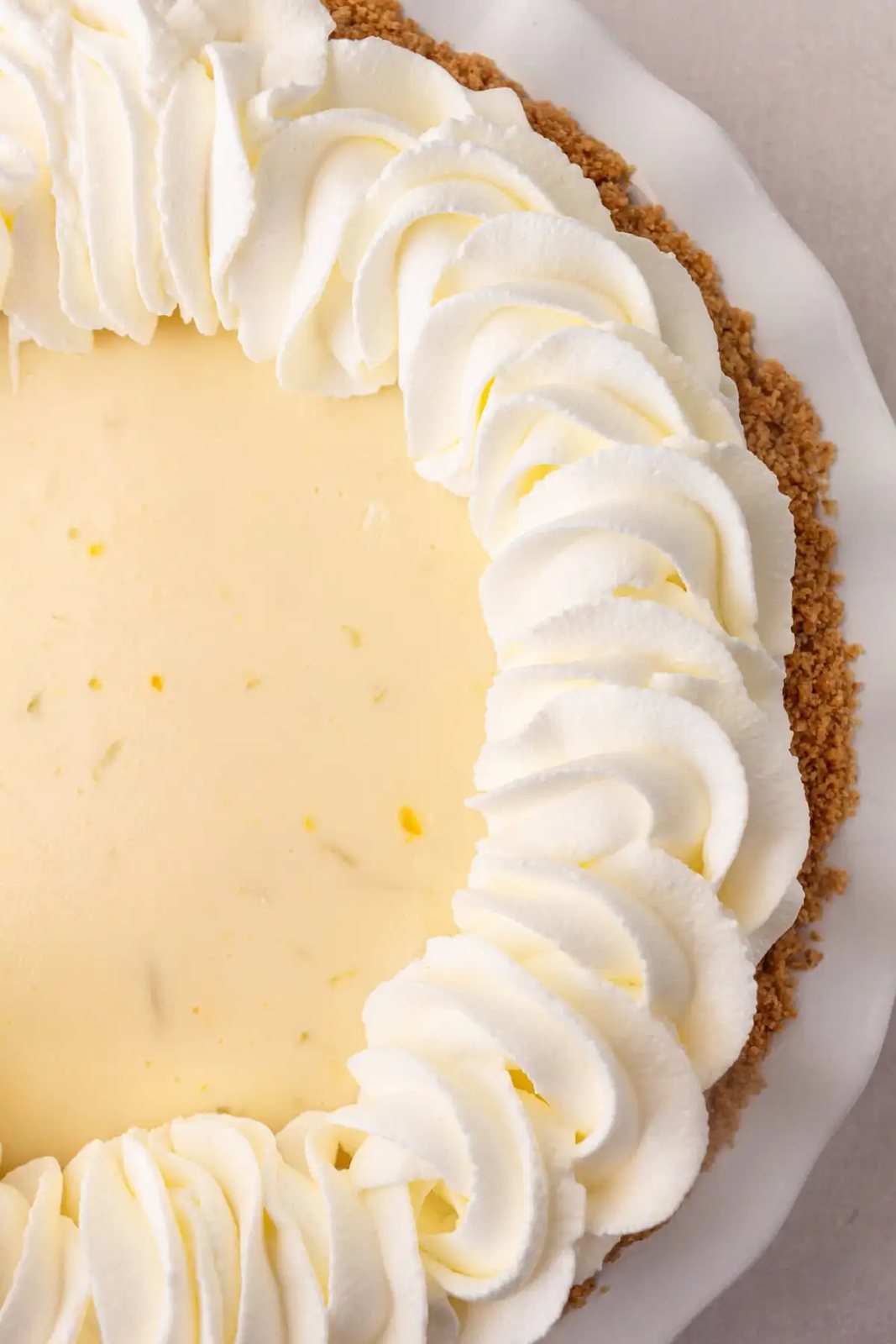 Fresh whipped cream piped on key lime pie