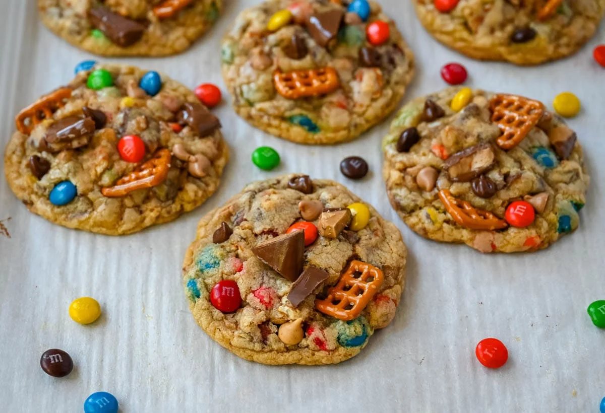 These Kitchen Sink Cookies are thick, soft, and chewy bakery-style cookies packed with chocolate chips, colorful M&M’s, crunchy pretzels, buttery toffee bits, and gooey caramel or peanut butter chips. Every bite is sweet, salty, crunchy, and chocolatey all at once. They’re called “kitchen sink” cookies because you can throw in everything but the kitchen sink, making them one of the most versatile and fully loaded cookie recipes you’ll ever bake.