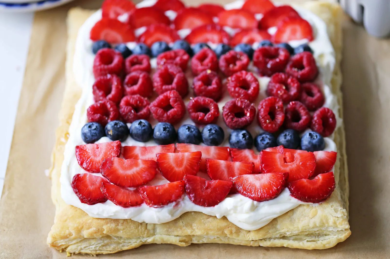 Lemon Berry Cheesecake Puff Pastry Baked Puff Pastry topped with Lemon Cheesecake Filling and Fresh Berries. An easy, beautiful, festive summer dessert. www.modernhoney.com