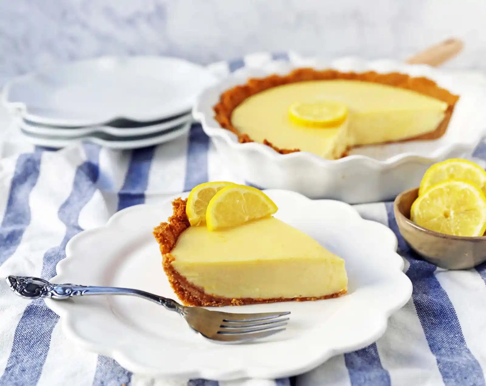 Lemon Cream Pie. A simple creamy lemon cream pie with fresh lemon zest in a buttery graham cracker crust with sweetened whipped cream. The BEST Lemon Pie Recipe. www.modernhoney.com #lemonpie #lemoncreampie #lemonpierecipe