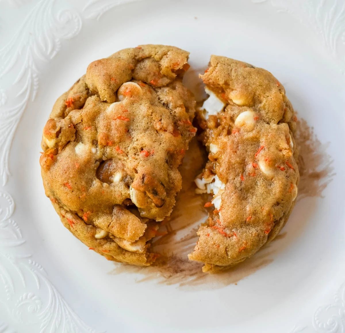 These Levain Bakery Carrot Cake Cookies are everything you love about carrot cake in a soft, thick cookie. Made with shredded carrots, warm spices, white chocolate chips, dried apricots and pecans, they are rich, flavorful, and perfectly chewy. A delicious spring dessert that’s easy to make at home!