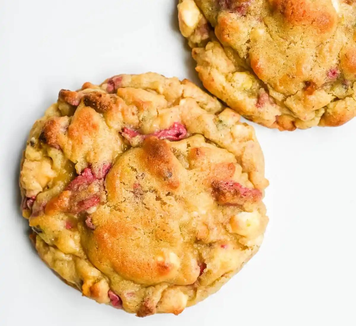 These Levain Bakery Raspberry Pistachio cookies are a homemade copycat of Levain Bakery's new summer flavor, which combines raspberry chips, crunchy pistachios, and creamy white chocolate chips in their signature thick, bakery-style cookie. Our version uses a homemade raspberry chip made from crushed freeze-dried raspberries and white chocolate for that same fruity flavor without needing specialty baking chips. These cookies are thick, gooey, and loaded with tart raspberry, rich white chocolate, and crunchy salted pistachios in every bite!