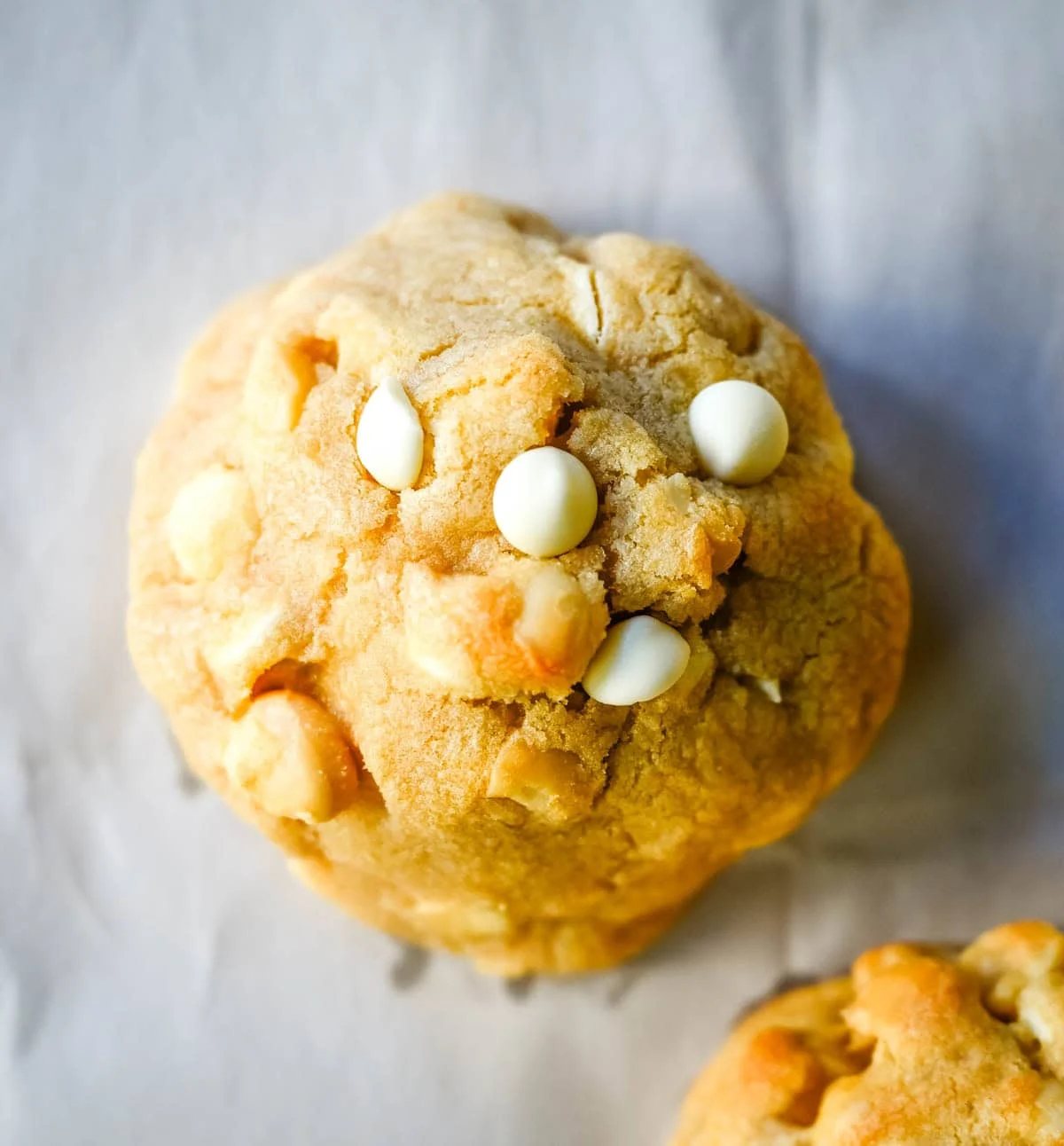 Soft in the center and crisp on the edges, these Levain Bakery White Chocolate Macadamia Cookies taste straight out of the bakery. This White Chocolate Macadamia Nut cookie recipe creates thick, buttery cookies loaded with creamy white chocolate chips and toasted macadamia nuts.