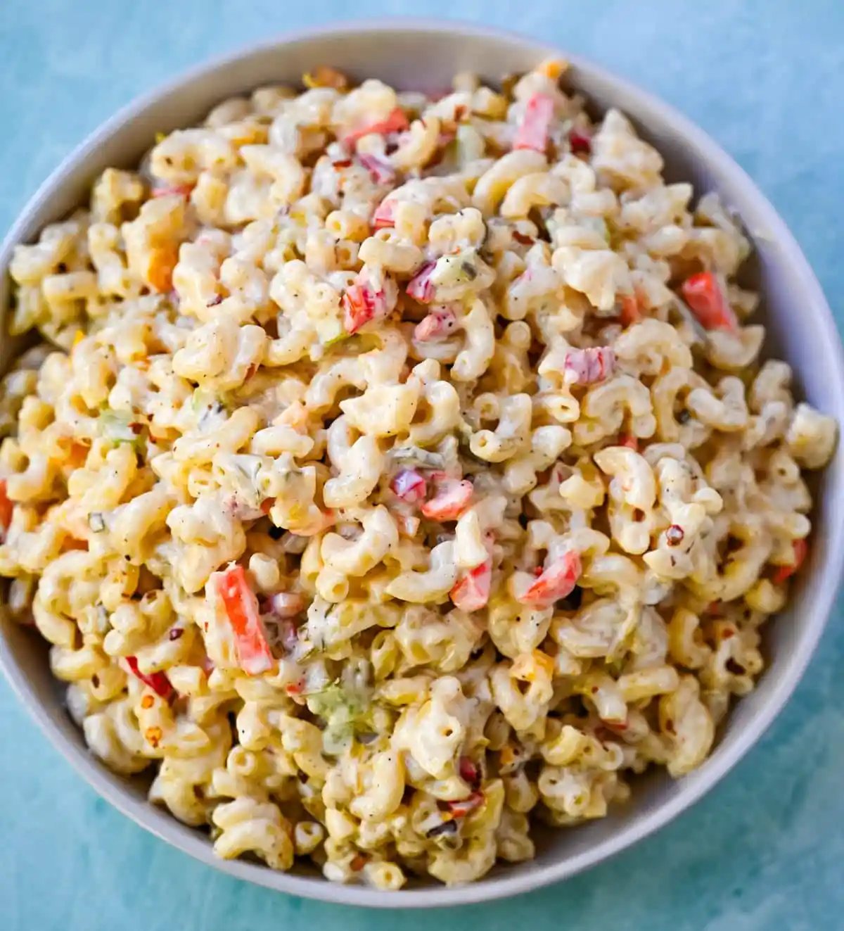 Tired of dry or bland macaroni salad? This creamy macaroni salad recipe is always a huge hit! Learn how to make the best creamy macaroni salad with this easy homemade recipe. Packed with crunchy vegetables, a rich mayo and sour cream dressing, and perfectly cooked pasta, this classic macaroni salad is always a crowd favorite.