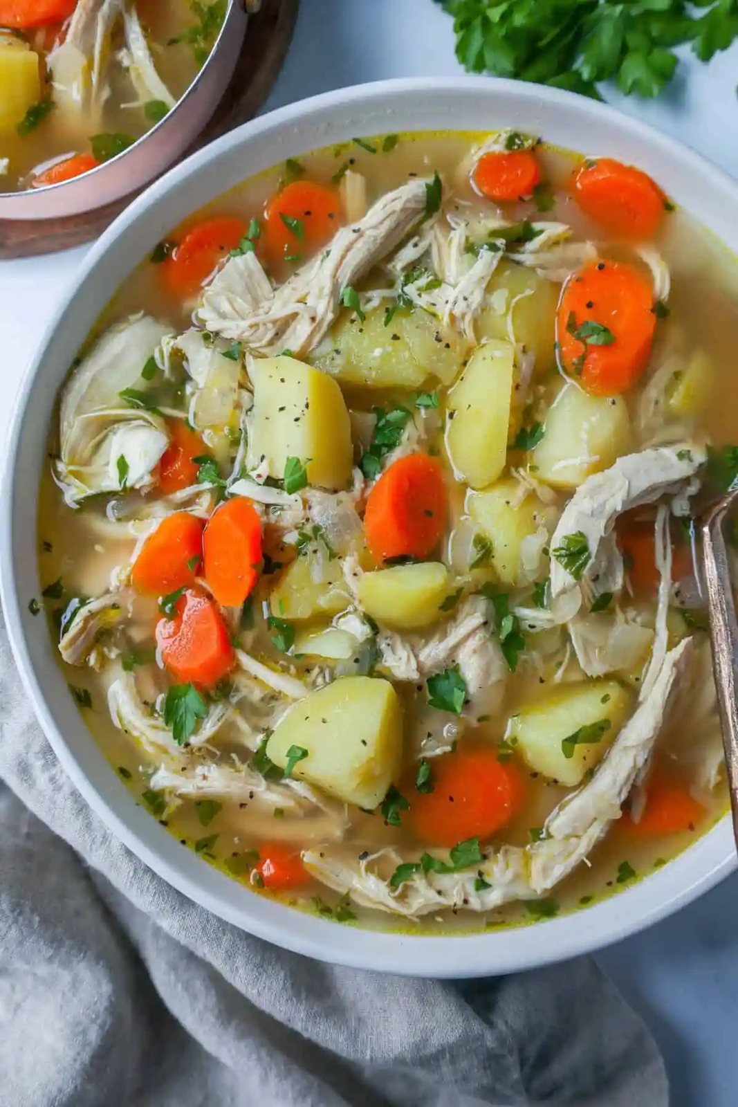 This Homemade Chicken Soup is made with tender chicken, carrots, onion, potatoes, fresh herbs, and seasonings all in a warm chicken broth. This is the perfect chicken soup on a cold winter's day.