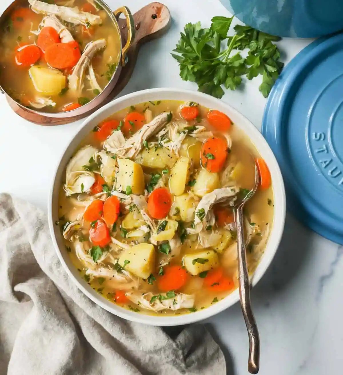 This Homemade Chicken Soup is made with tender chicken, carrots, onion, potatoes, fresh herbs, and seasonings all in a warm chicken broth. This is the perfect chicken soup on a cold winter's day.