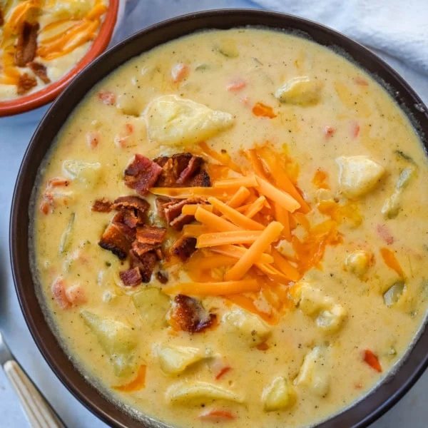 This creamy potato soup is the definition of comfort in a bowl made with buttery Yukon gold potatoes, crispy bacon, cheddar cheese, and a splash of heavy cream come together to make the richest, coziest soup ever. You will love this Potato Cheese Soup Recipe!