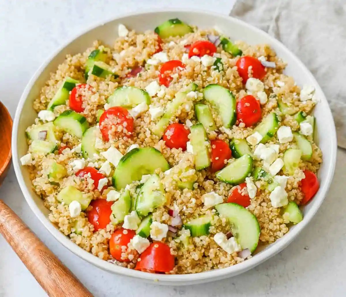 A light and healthy quinoa salad made with quinoa, crunchy cucumbers, fresh tomatoes, crisp red onion, and tangy feta tossed in a red wine vinaigrette. The perfect side dish or healthy meal!