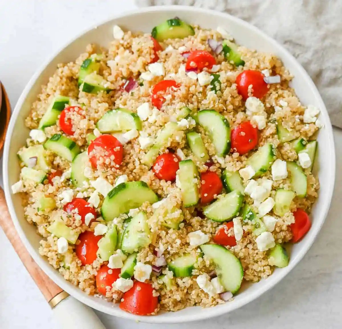 A light and healthy quinoa salad made with quinoa, crunchy cucumbers, fresh tomatoes, crisp red onion, and tangy feta tossed in a red wine vinaigrette. The perfect side dish or healthy meal!
