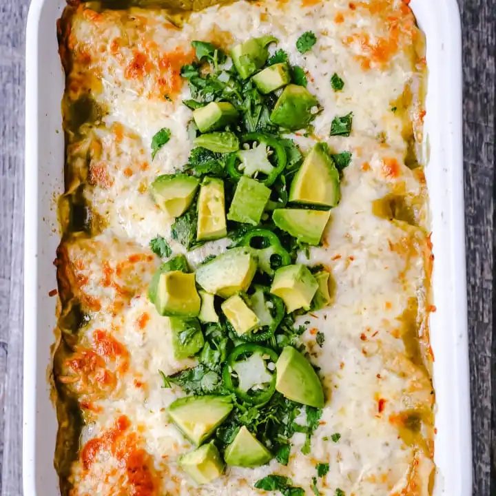 Creamy Green Chile Chicken Enchiladas Creamy chicken enchiladas stuffed with a cream cheese and sour cream green chile chicken rolled into corn tortillas and topped with green enchilada sauce and pepper jack cheese. The best creamy chicken enchiladas recipe! www.moderrnhoney.com #enchiladas #mexicanfood