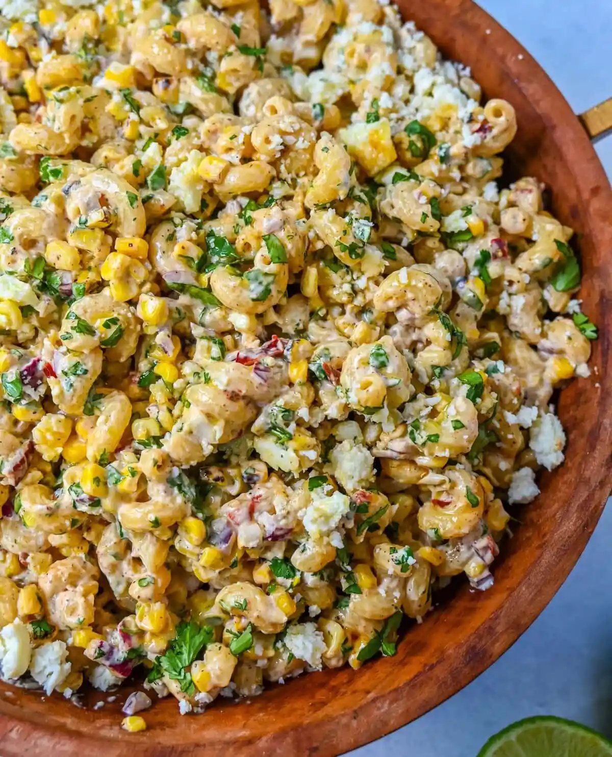 This Mexican Street Corn Pasta Salad is made with fresh corn, pasta, red onion, jalapeno, fresh cilantro, all tossed in a perfectly spiced dressing and topped with cotija cheese, Mexican spices, and fresh lime. It’s street food meets comfort food and it is so addictive. Perfect for a summer BBQ, potluck dish, or the perfect side dish, this Mexican Street Corn Pasta Salad delivers every time.