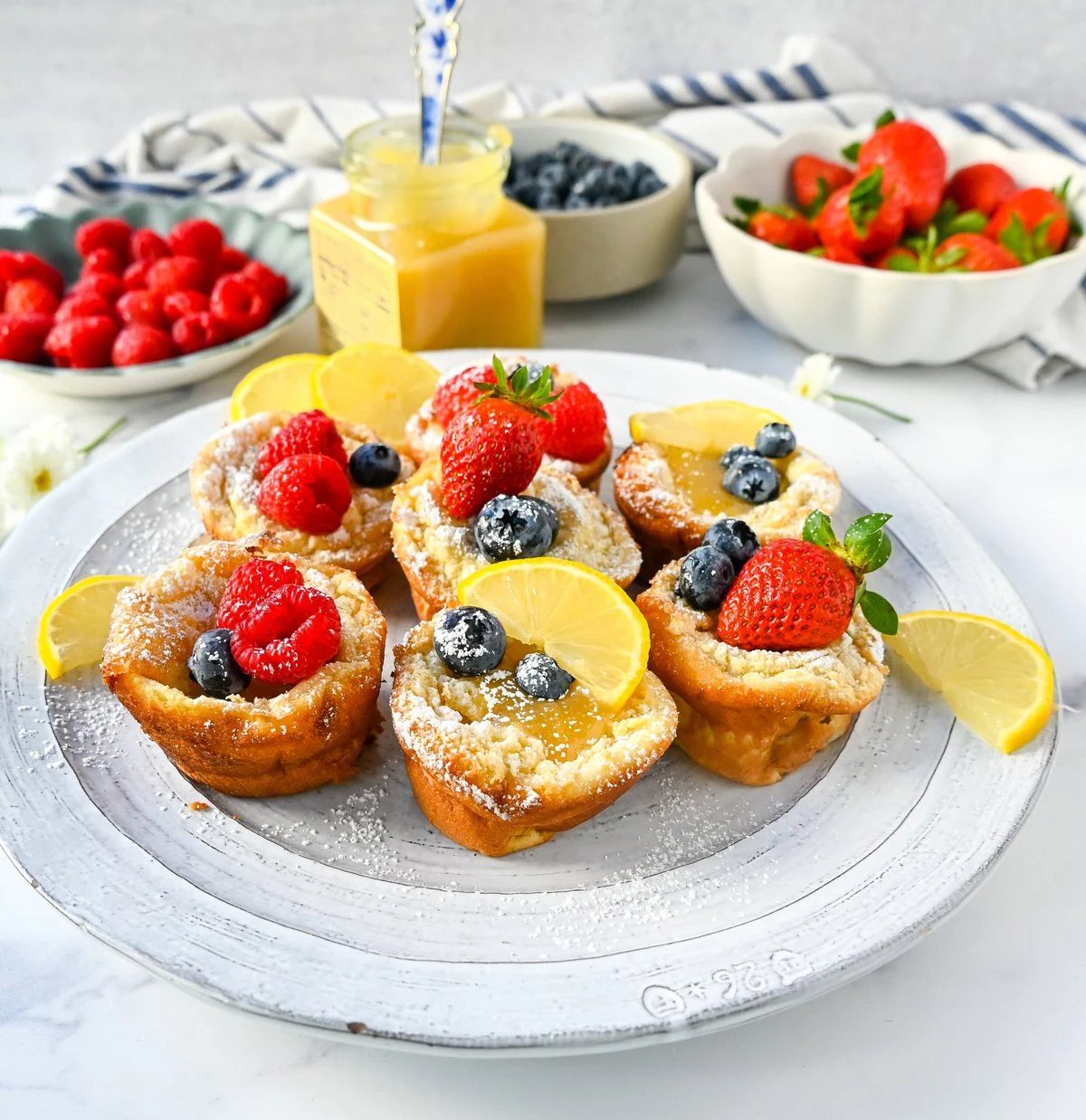 Mini Dutch Baby Pancakes (in a muffin tin). These mini, bite-size Dutch Baby pancakes are made the same way as traditional German pancakes but these are baked in muffin tins. These easy, golden and buttery mini puffed pancakes are perfect to serve to family and friends.