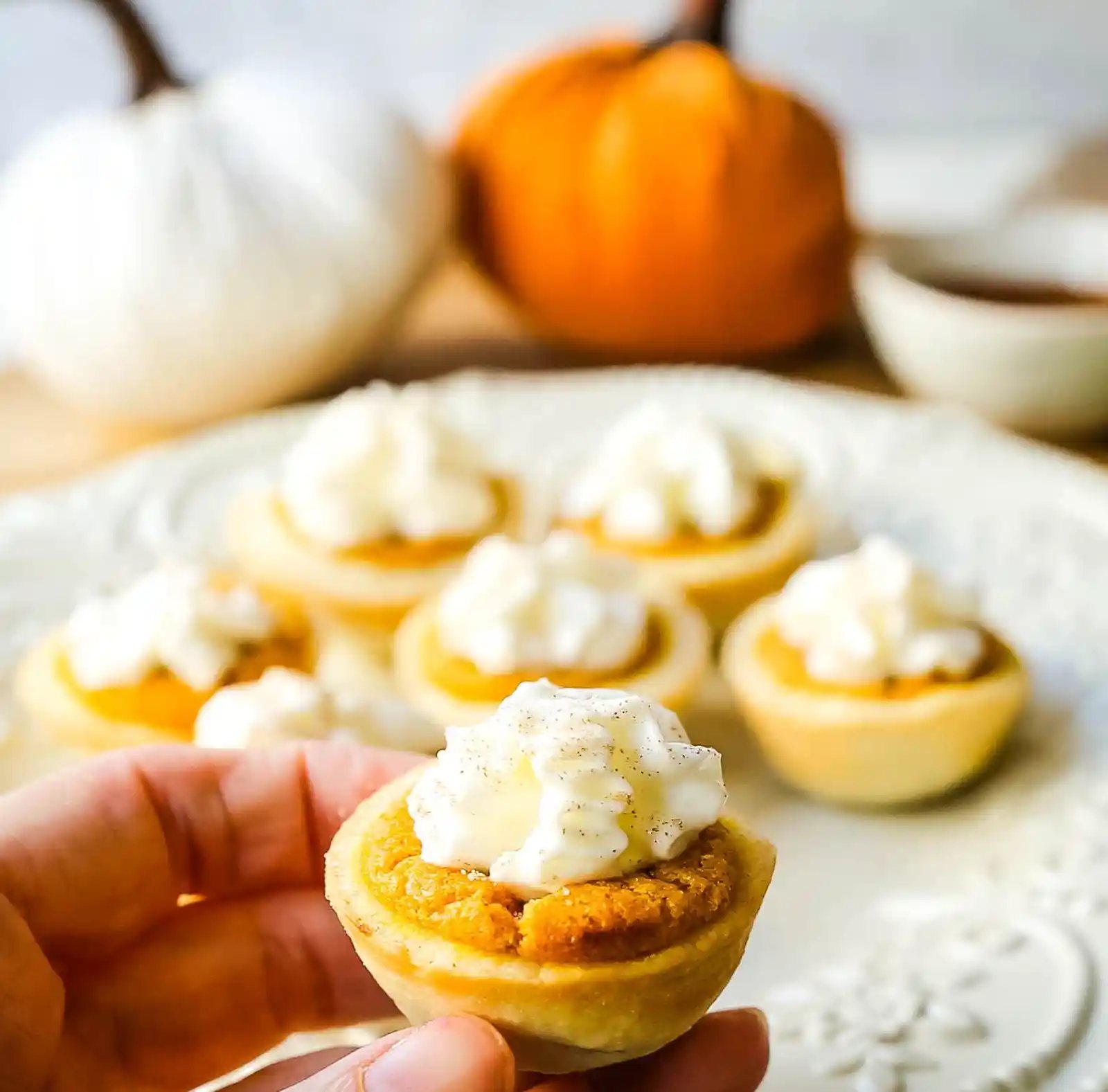 Mini Pumpkin Pie Bites. The best bite-size mini pumpkin pies perfect for entertaining during the holiday season. Creamy pumpkin pie filling in buttery pie crust cups topped with fresh whipped cream. www.modernhoney.com #pumpkinpie #pumpkinpiebites #minipumpkinpies