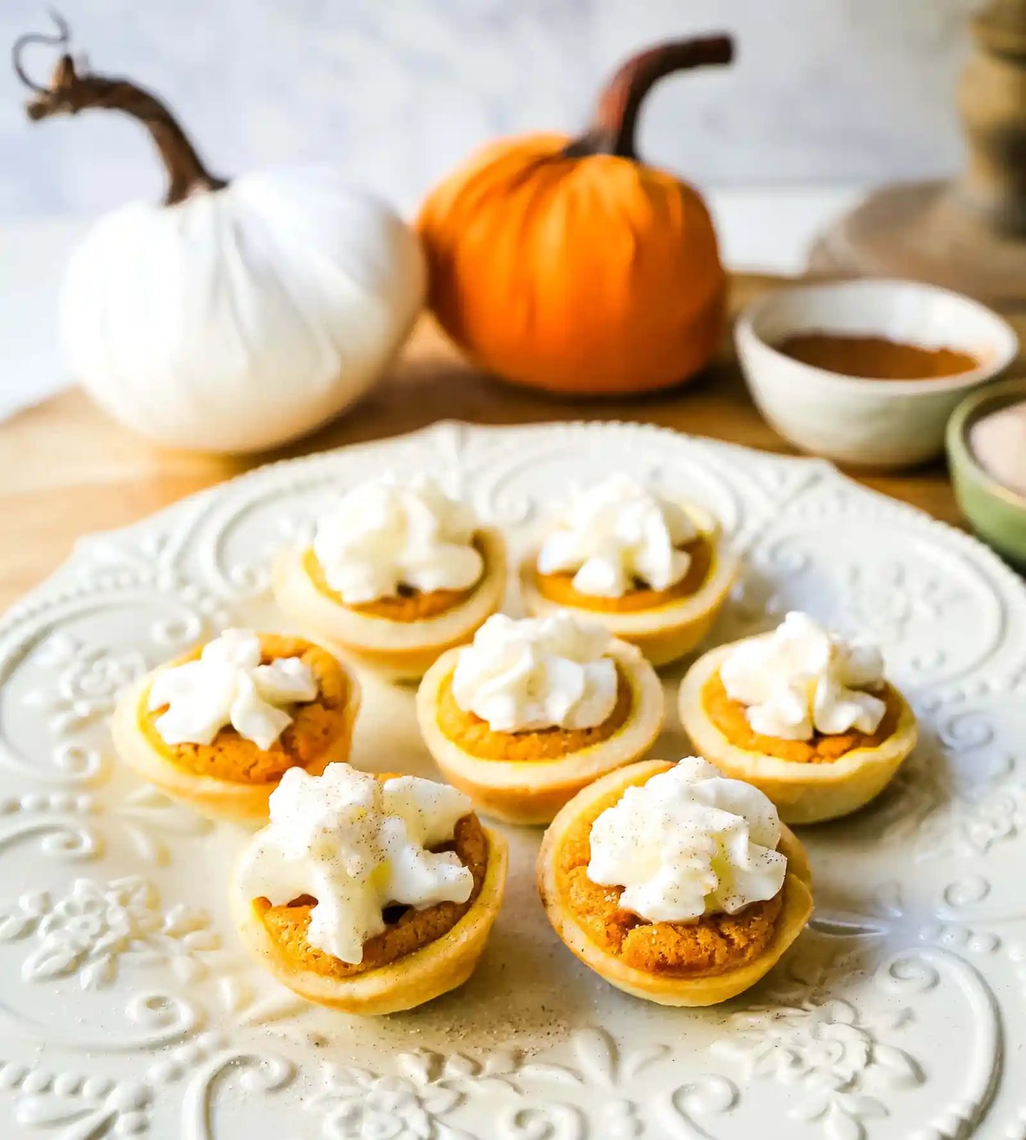 Mini Pumpkin Pie Bites. The best bite-size mini pumpkin pies perfect for entertaining during the holiday season. Creamy pumpkin pie filling in buttery pie crust cups topped with fresh whipped cream. www.modernhoney.com #pumpkinpie #pumpkinpiebites #minipumpkinpies