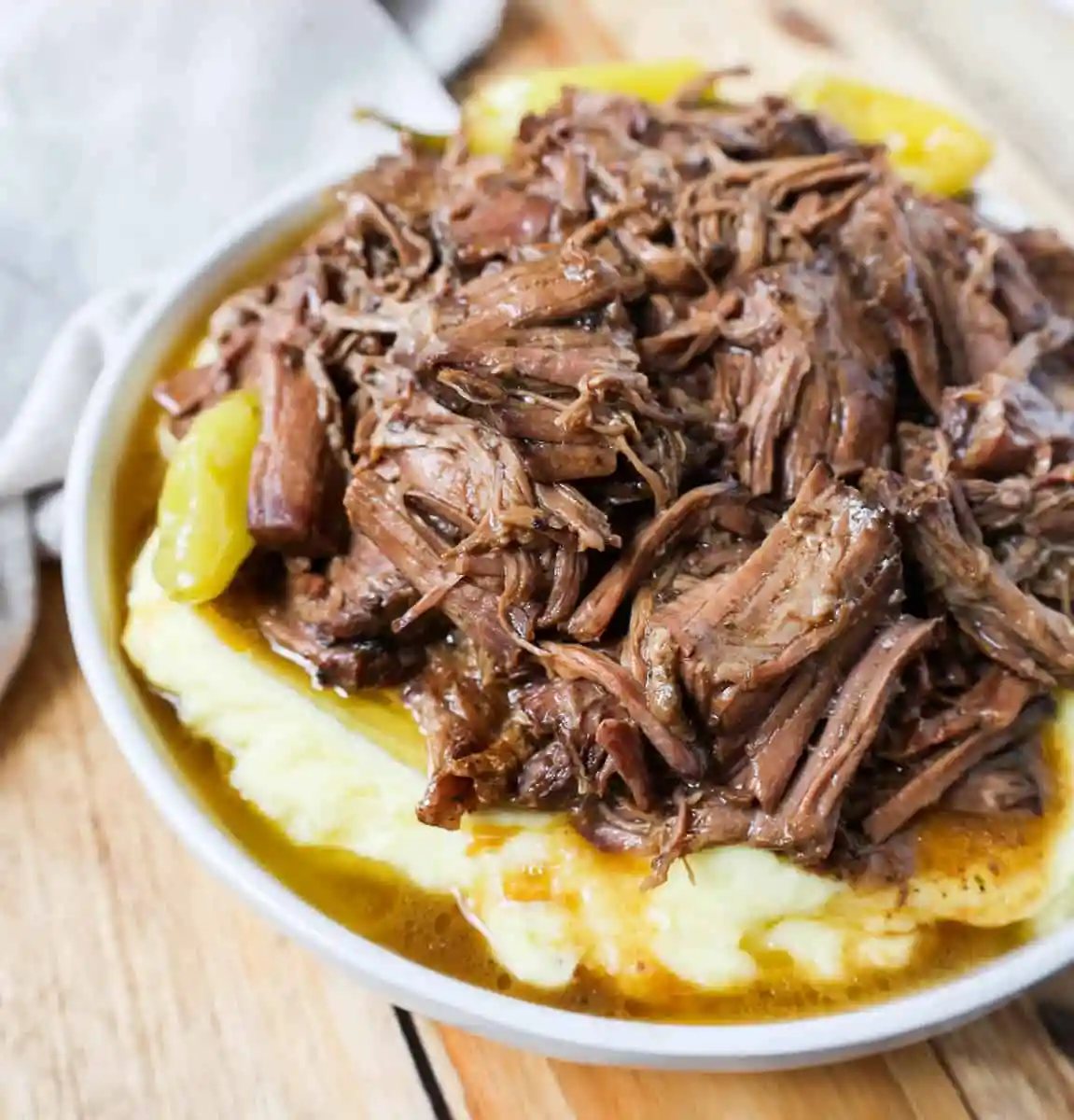 This Mississippi Pot Roast Recipe with mashed potatoes is the most tender, flavorful, melt-in-your-mouth beef roast recipe and is made with only five ingredients. This is the best beef pot roast recipe ever and is slow cooked in a crockpot.