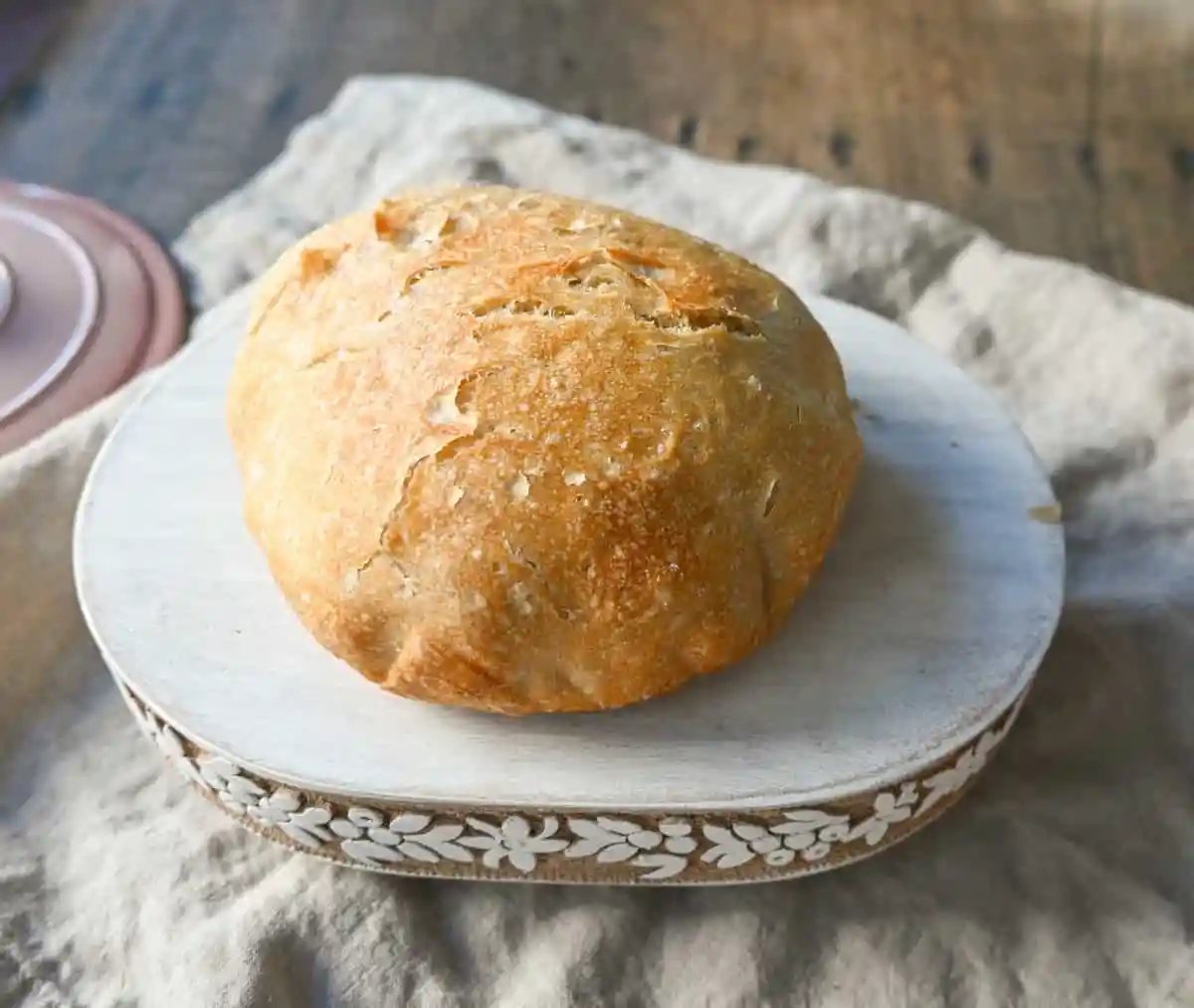 No Knead Overnight Crusty Bread Recipe. This No Knead Bread is baked in a dutch oven and is the perfect crusty french bread recipe. This makes a beautiful artisan loaf of bread and is so easy! The only ingredients you need are flour, water, salt, and yeast for the perfect overnight crusty bread.