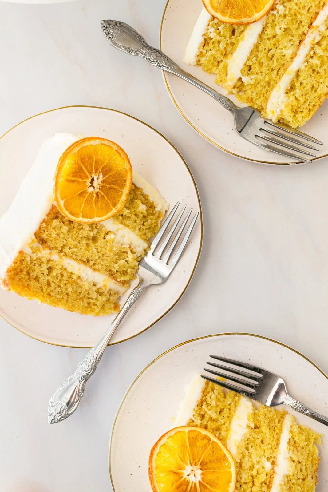 A moist, tender fresh orange cake with a sweet orange cream cheese frosting. This homemade orange cake that is bursting with bright citrus flavor in every bite. Each layer is moist, fluffy, and perfectly enhanced by an orange cream cheese frosting. The fresh orange juice and zest adds fresh orange flavor. Here are tips for making the perfect frosted orange cake! This can also be made into an orange naked cake.