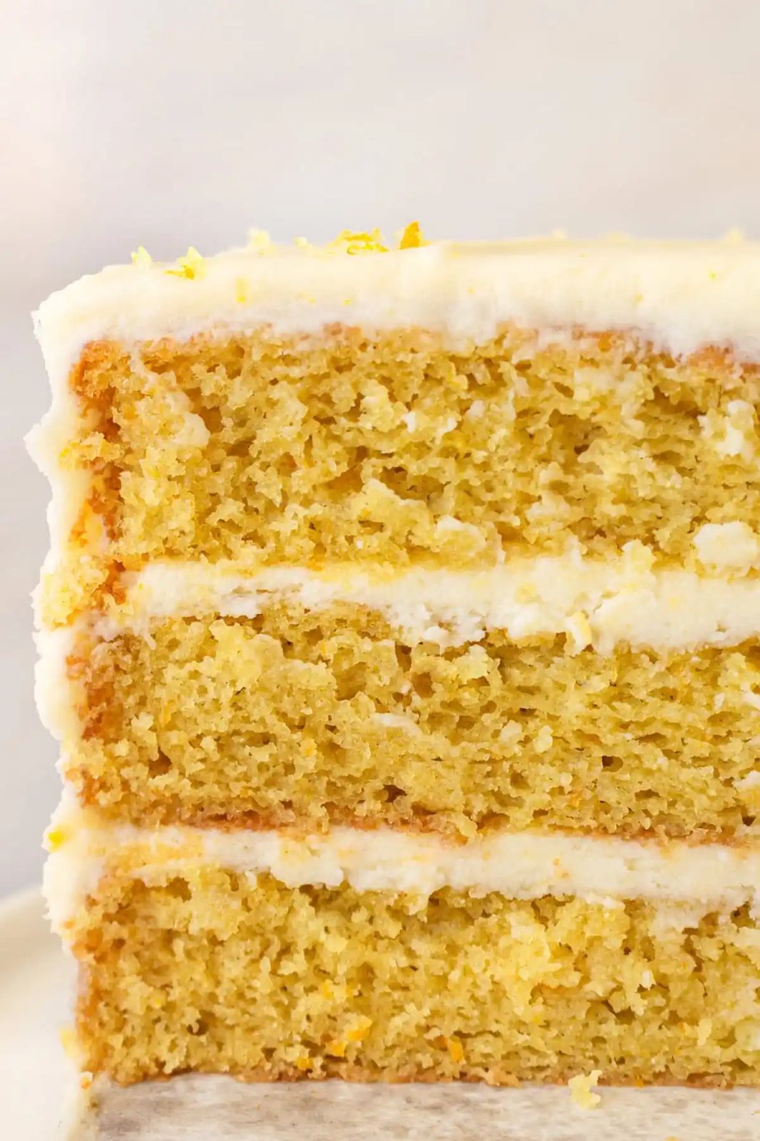 A moist, tender fresh orange cake with a sweet orange cream cheese frosting. This homemade orange cake that is bursting with bright citrus flavor in every bite. Each layer is moist, fluffy, and perfectly enhanced by an orange cream cheese frosting. The fresh orange juice and zest adds fresh orange flavor. Here are tips for making the perfect frosted orange cake! This can also be made into an orange naked cake.