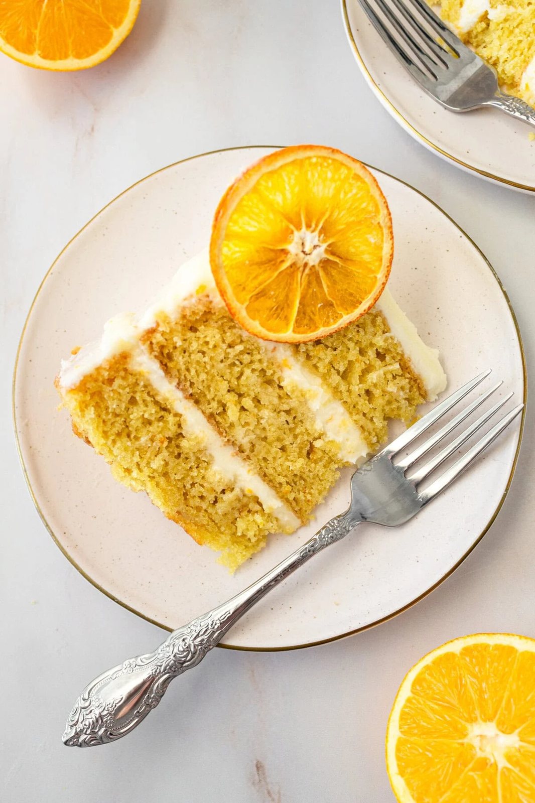 A moist, tender fresh orange cake with a sweet orange cream cheese frosting. This homemade orange cake that is bursting with bright citrus flavor in every bite. Each layer is moist, fluffy, and perfectly enhanced by an orange cream cheese frosting. The fresh orange juice and zest adds fresh orange flavor. Here are tips for making the perfect frosted orange cake! This can also be made into an orange naked cake.