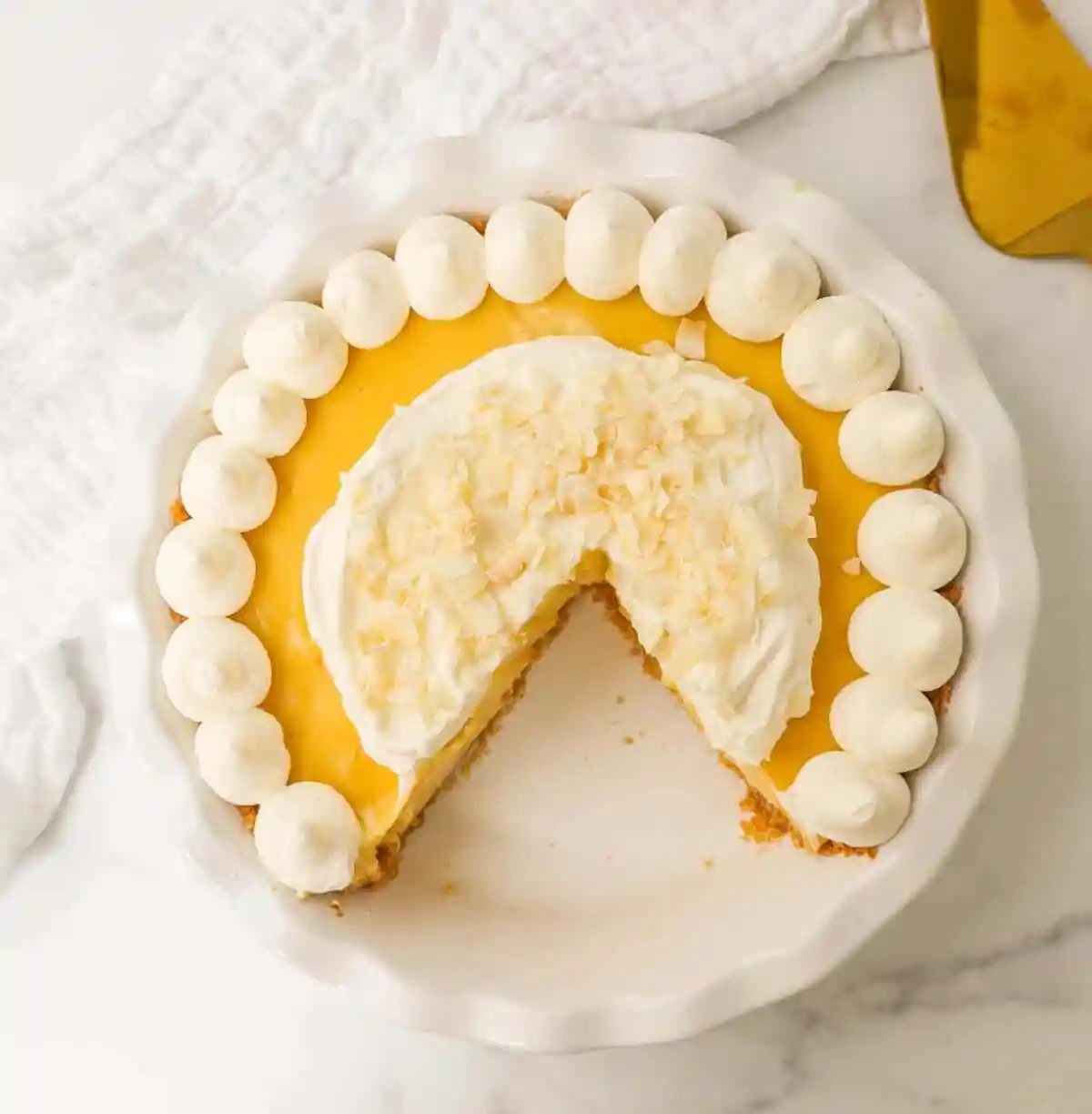 Creamy Passion Fruit Pie topped with fresh whipped cream is the perfect tropical cream pie recipe that will make you feel like you are in Hawaii! This Lilikoi Pie is similar to a key lime pie but made with passion fruit. This Passionfruit pie is made with a graham cracker crust, creamy passion fruit custard filling, and topped with billowy sweet whipped cream.