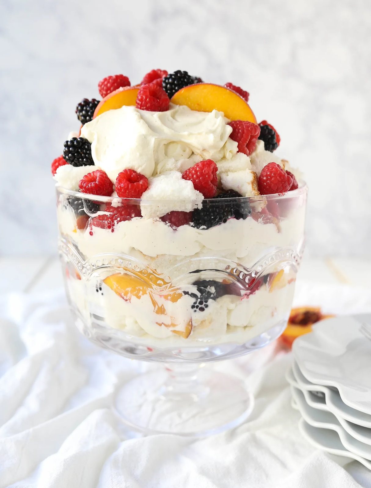 Peach Berry Trifle Angel food cake, a sweet, creamy, fluffy filling with fresh peaches and raspberries makes this the perfect summer dessert. www.modernhoney.com #peach #peacherecipes #trifle #dessert