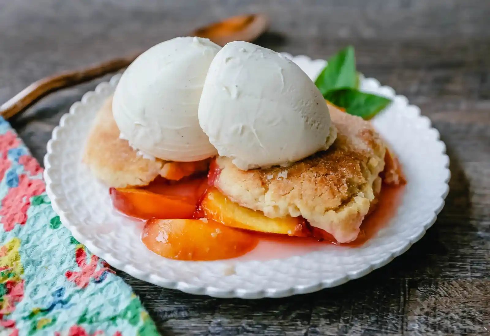 Peach Cobbler. The Best Peach Cobbler Recipe! Fresh peaches tossed with a touch of sugar and topped with a homemade sweet and buttery topping that resembles a mix of a sugar cookie and a sweet biscuit.