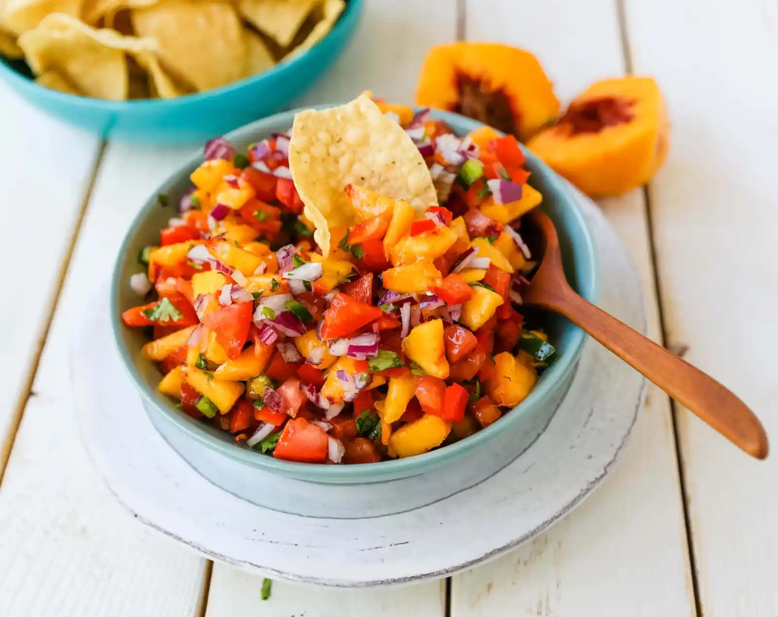 Peach Salsa. Fresh peach salsa with red pepper, jalapeño, red onion, tomatoes, cilantro, and fresh lime juice. A sweet and savory salsa perfect to pair with chips, grilled chicken or pork. www.modernhoney.com #peachsalsa #salsa #peachrecipes