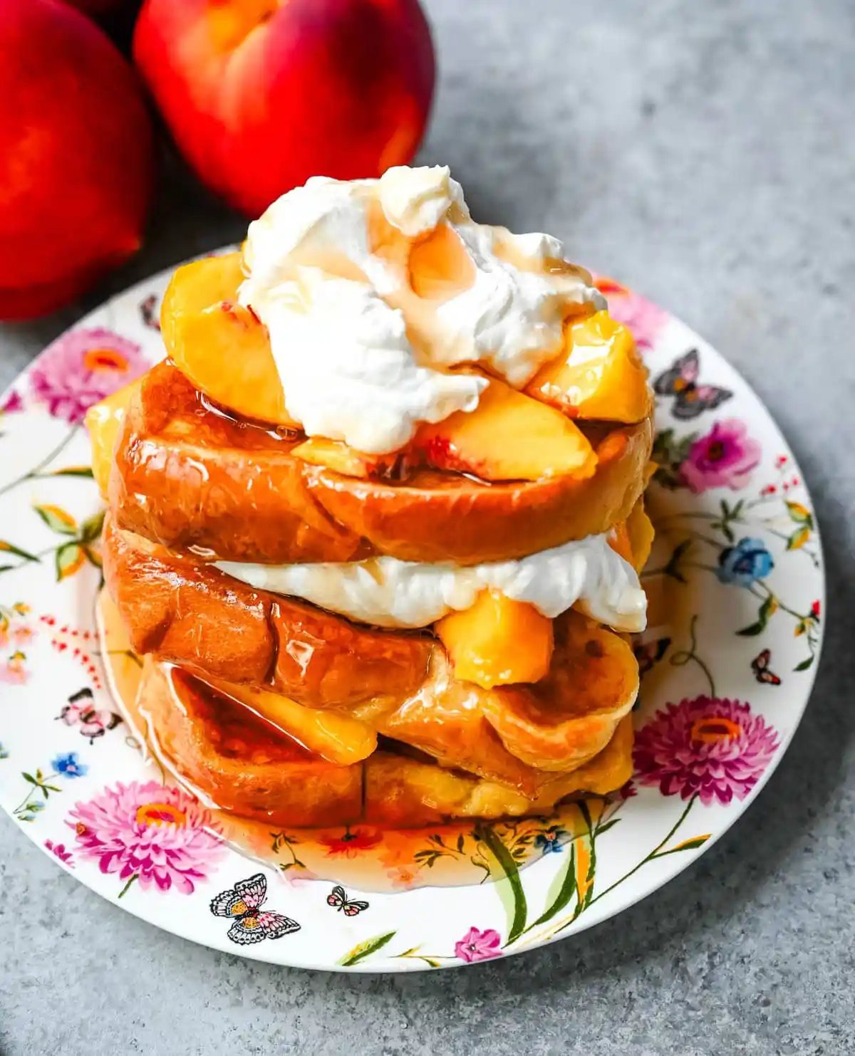 This Peaches and Cream French toast is made with thick slices of challah or brioche bread soaked in a rich, creamy custard, then topped with fresh whipped cream, juicy peaches, and real maple syrup. It's the ultimate easy peach French toast recipe.