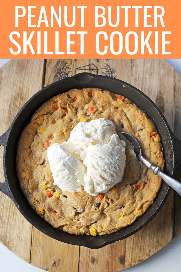 Peanut Butter Skillet Cookie. Homemade peanut butter cookie dough with Reeses Pieces baked until ooey gooey and topped with vanilla ice cream and hot fudge. www.modernhoney.com #peanutbutter #peanutbuttercookies #peanutbutterpizookie #pizookie