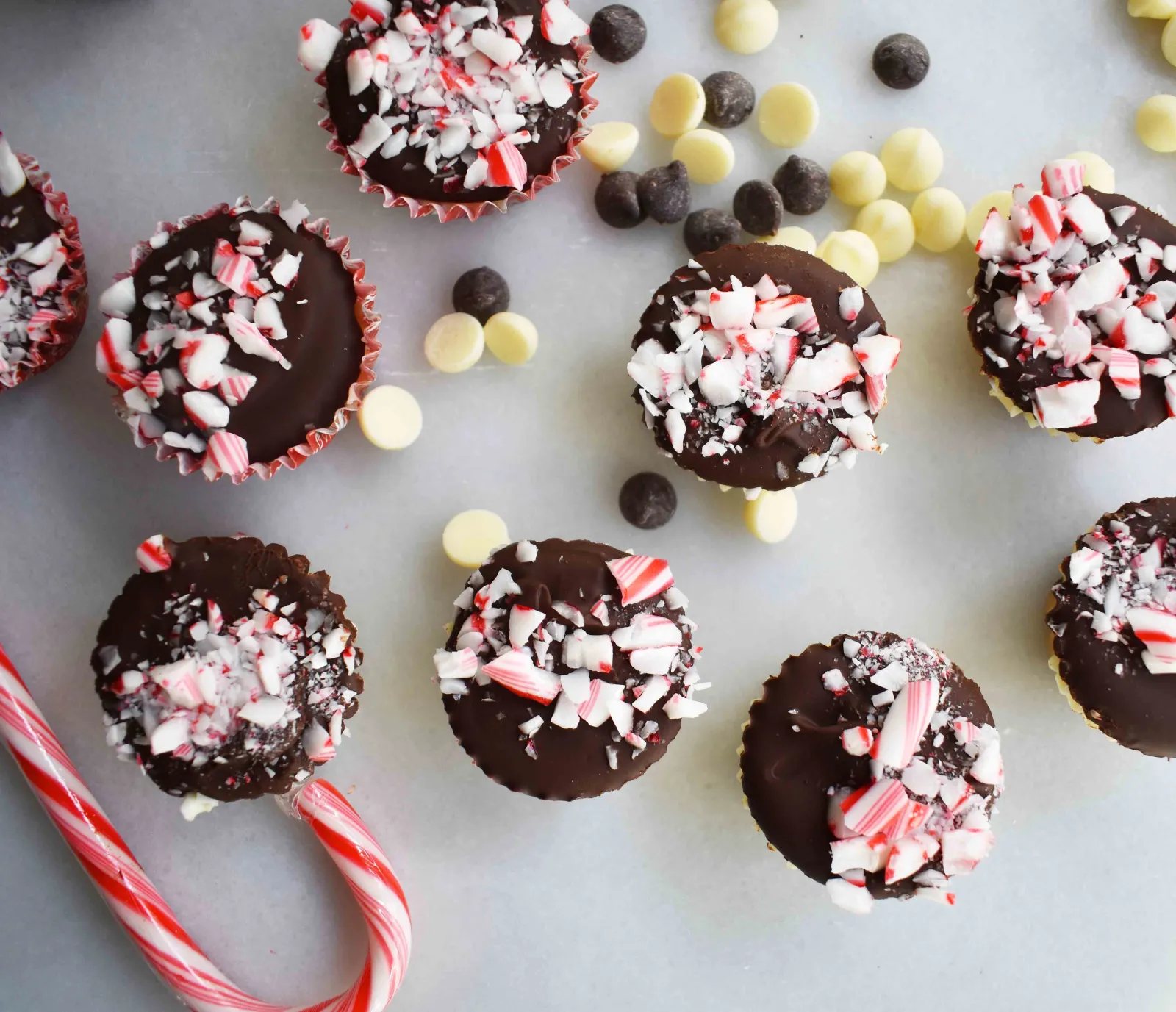 Peppermint Bark Cookie Dough Cups by Modern Honey. Egg Free Chocolate Chip Cookie Dough layered with white chocolate and semisweet chocolate and topped with crushed candy canes.