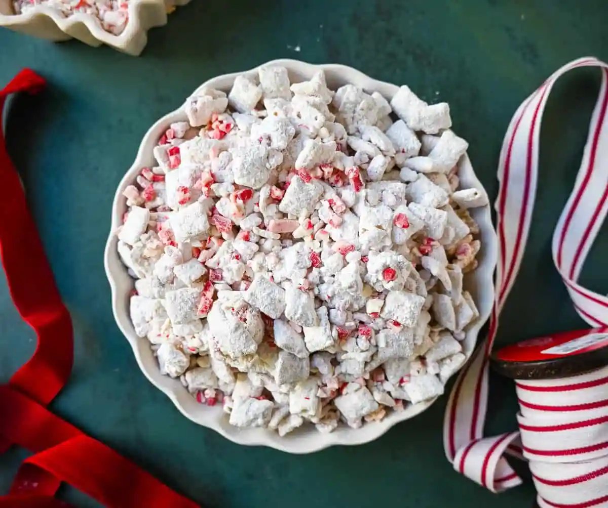 Peppermint Puppy Chow, also known as Peppermint Muddy Buddies, Peppermint Chex Mix, or Peppermint Bark Muddy Buddies, is a festive and addictive holiday treat. It is a variation of the classic Muddy Buddies, but is made with Rice Chex cereal, white chocolate, peppermint bark or candy canes, and powdered sugar.