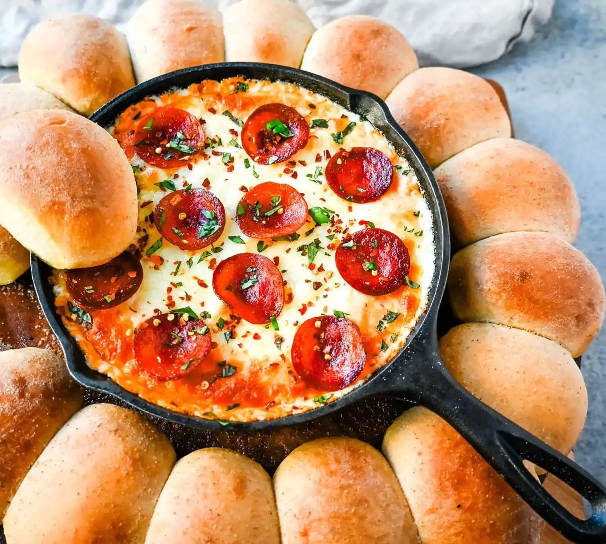 Hot Pepperoni Pizza Dip is a delicious and cheesy appetizer that brings all the classic pizza flavors. Loaded with melted cheeses, tangy marinara sauce, creamy cream cheese, and plenty of crispy pepperoni, this party dip is perfect for game days, potlucks, or get-togethers. It’s an easy appetizer recipe that can be whipped up in no time with minimal effort. The hot pepperoni pizza dip pairs well with homemade pizza dough rolls.
