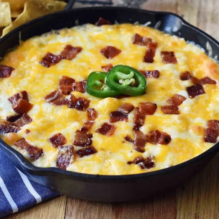 Creamy Jalapeno Popper Dip with Bacon. Homemade Jalapeno Popper Dip made with cream cheese, sour cream, mayo, fresh jalapenos, two kinds of Mexican cheeses, and crispy bacon. The perfect party appetizer. This Jalapeno Popper Dip is so popular! www.modernhoney.com