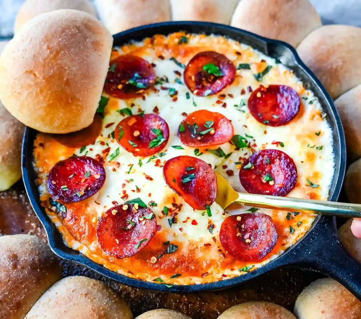 Hot Pepperoni Pizza Dip is a delicious and cheesy appetizer that brings all the classic pizza flavors. Loaded with melted cheeses, tangy marinara sauce, creamy cream cheese, and plenty of crispy pepperoni, this party dip is perfect for game days, potlucks, or get-togethers. It’s an easy appetizer recipe that can be whipped up in no time with minimal effort. The hot pepperoni pizza dip pairs well with homemade pizza dough rolls.