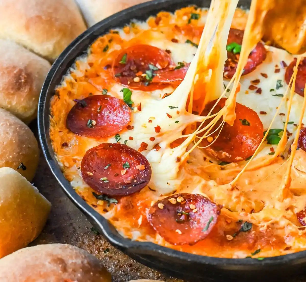Hot Pepperoni Pizza Dip is a delicious and cheesy appetizer that brings all the classic pizza flavors. Loaded with melted cheeses, tangy marinara sauce, creamy cream cheese, and plenty of crispy pepperoni, this party dip is perfect for game days, potlucks, or get-togethers. It’s an easy appetizer recipe that can be whipped up in no time with minimal effort. The hot pepperoni pizza dip pairs well with homemade pizza dough rolls.