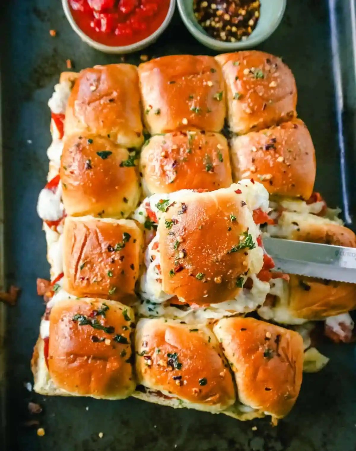 Pizza Sliders. Hawaiian Rolls Pizza Sliders made with Pepperoni, Mozzarella Cheese, and Provolone Cheese baked inside of soft, sweet rolls topped with warmed garlic butter and dipped in marinara sauce. The perfect party food!