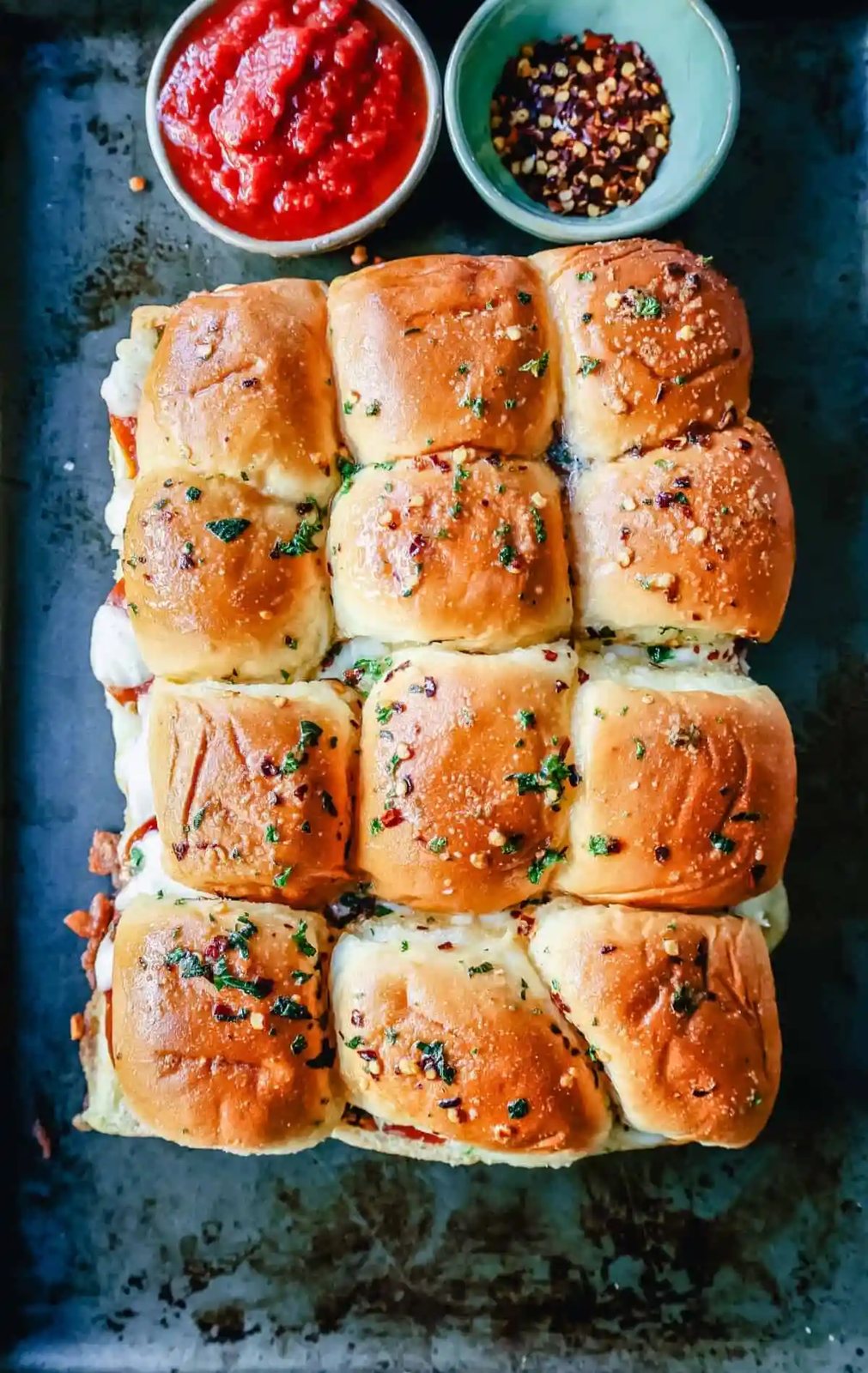 Pizza Sliders. Hawaiian Rolls Pizza Sliders made with Pepperoni, Mozzarella Cheese, and Provolone Cheese baked inside of soft, sweet rolls topped with warmed garlic butter and dipped in marinara sauce. The perfect party food!