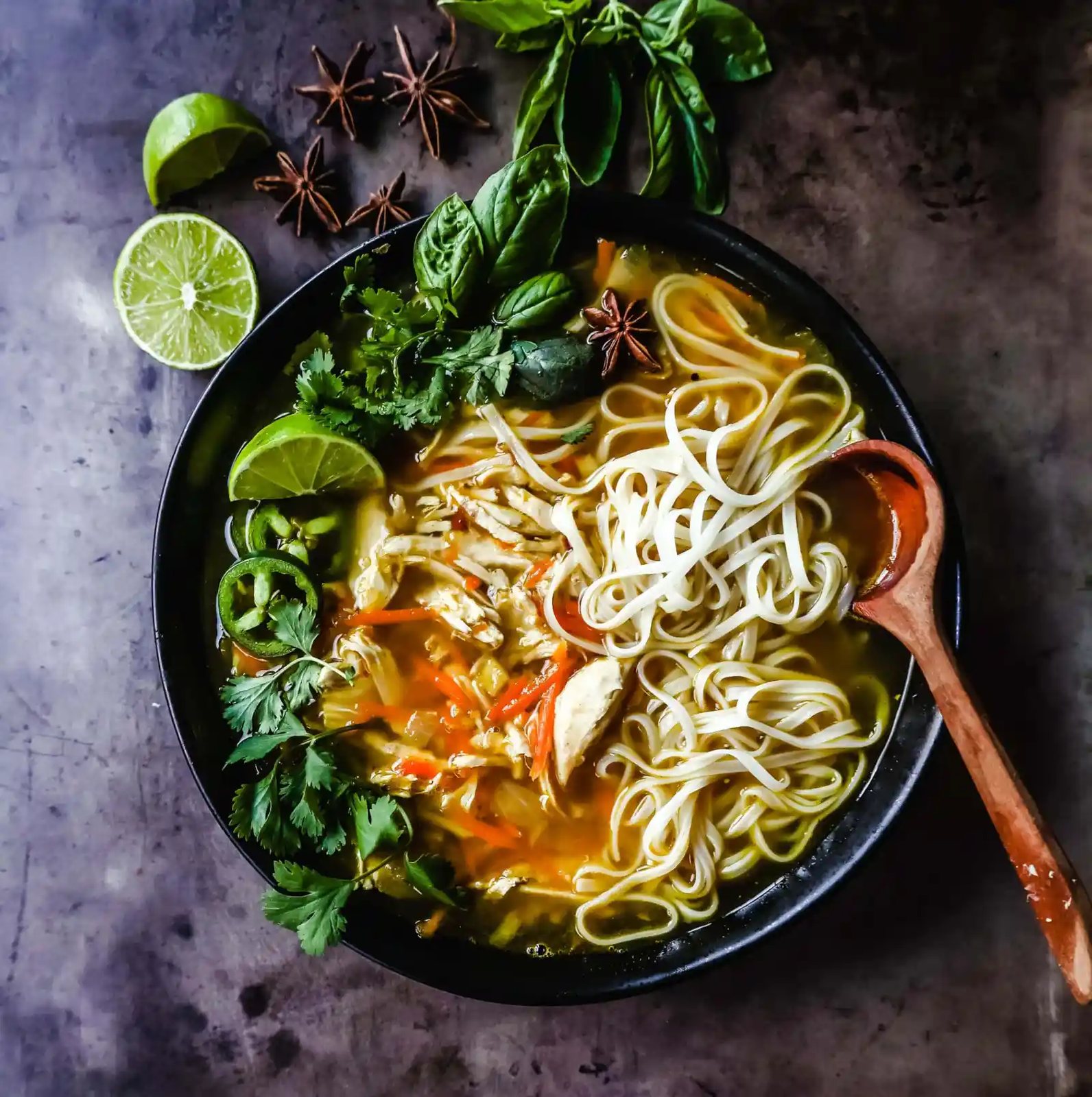 Quick and Easy Chicken Pho with tender chicken, warm broth, garlic, ginger, spices, fresh vegetables, and a touch of spice. This is a version of the popular Vietnamese Chicken Pho soup.
