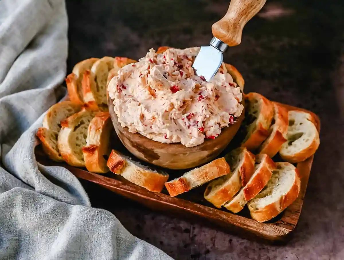 This pimento cheese dip is famous in the South for good reason. This pimento dip is made with cream cheese, mayonnaise, two types of cheddar cheeses, chopped pimentos, cayenne pepper, and a touch of salt.