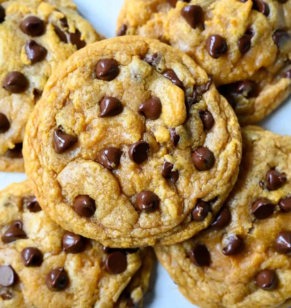 These pumpkin chocolate chip cookies are soft, chewy, and loaded with melty chocolate, with none of the cakey, muffin-top texture most pumpkin cookies have. Brown butter gives them a deep toffee-caramel flavor, and one simple trick with the pumpkin purée is what keeps them chewy instead of puffy.