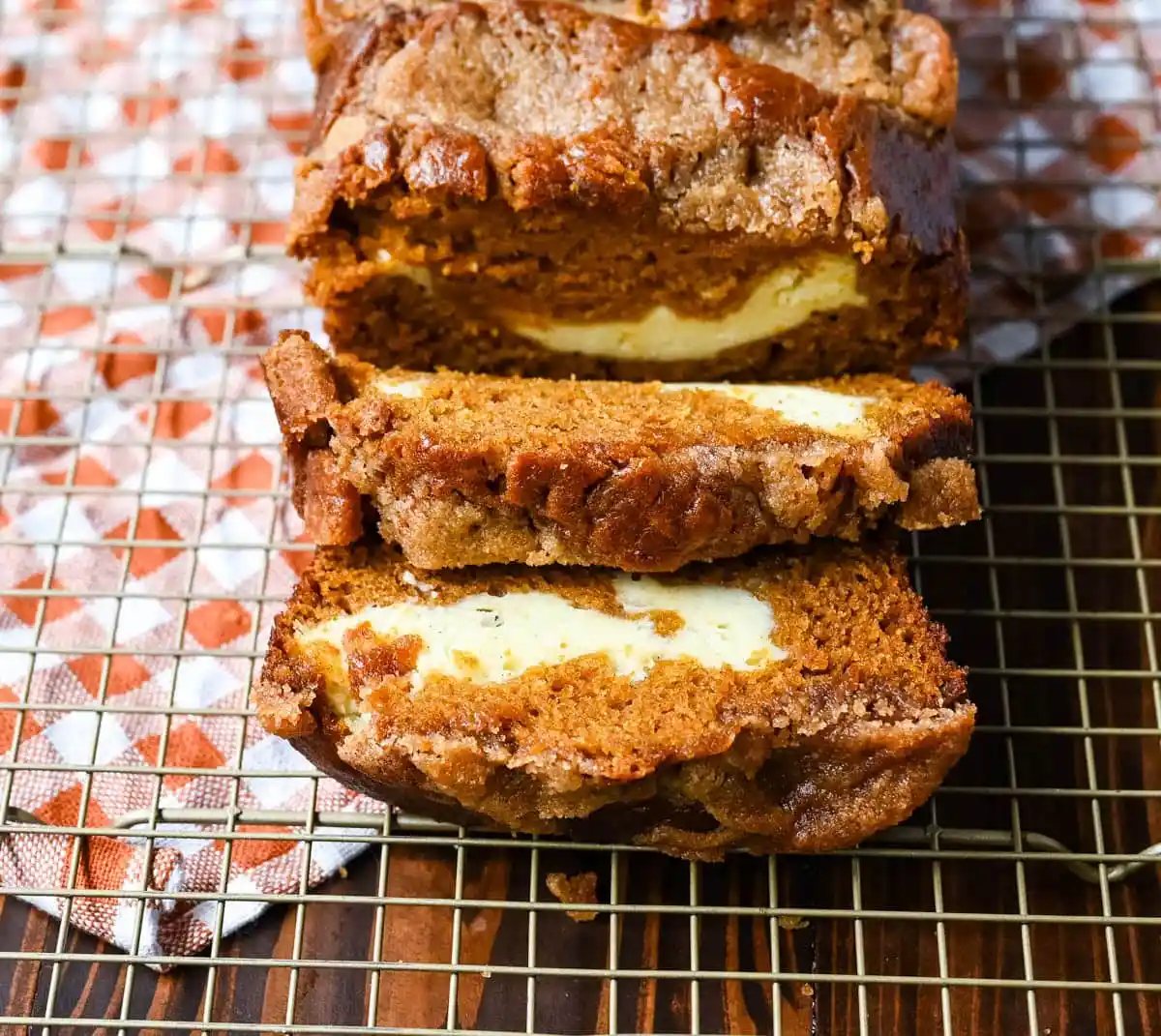 This pumpkin cream cheese bread has a thick ribbon of tangy cheesecake running through the middle, a buttery brown sugar streusel on top, and one simple trick that gives it the deepest, richest pumpkin flavor you've had in a loaf. This is the best pumpkin cream cheese bread recipe and it makes two loaves.