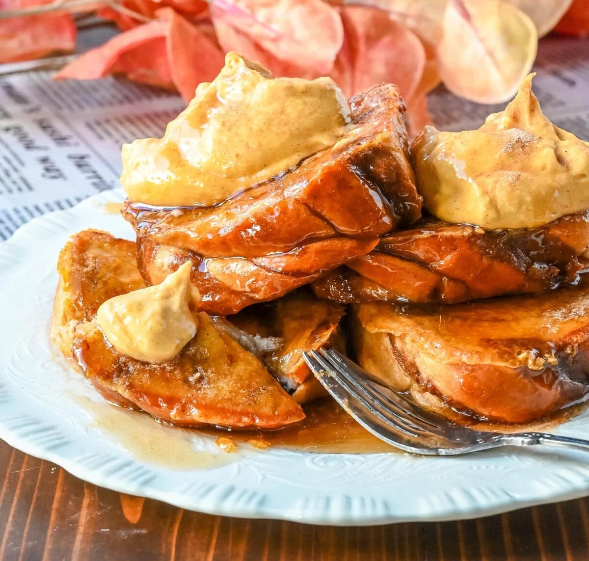 This Pumpkin French Toast is the perfect fall breakfast! Made with pumpkin puree, pumpkin spice, and thick slices of brioche cinnamon bread, it’s golden on the outside, soft inside, and topped with a dollop of sweet brown sugar pumpkin spice cream cheese.
