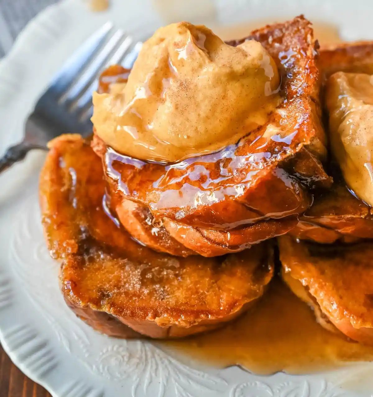 This Pumpkin French Toast is the perfect fall breakfast! Made with pumpkin puree, pumpkin spice, and thick slices of brioche cinnamon bread, it’s golden on the outside, soft inside, and topped with a dollop of sweet brown sugar pumpkin spice cream cheese.