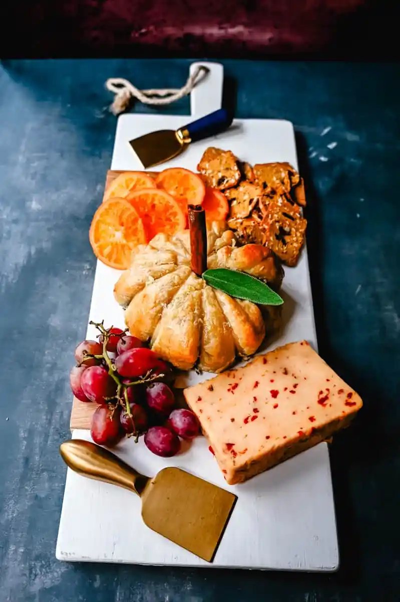 Pumpkin Shaped Baked Brie Puff Pastry. This festive Fall Pumpkin Baked Brie is the perfect appetizer or centerpiece for your charcuterie board. Flaky puff pastry baked with creamy brie cheese and pumpkin butter or fig jam is the perfect salty sweet combination.