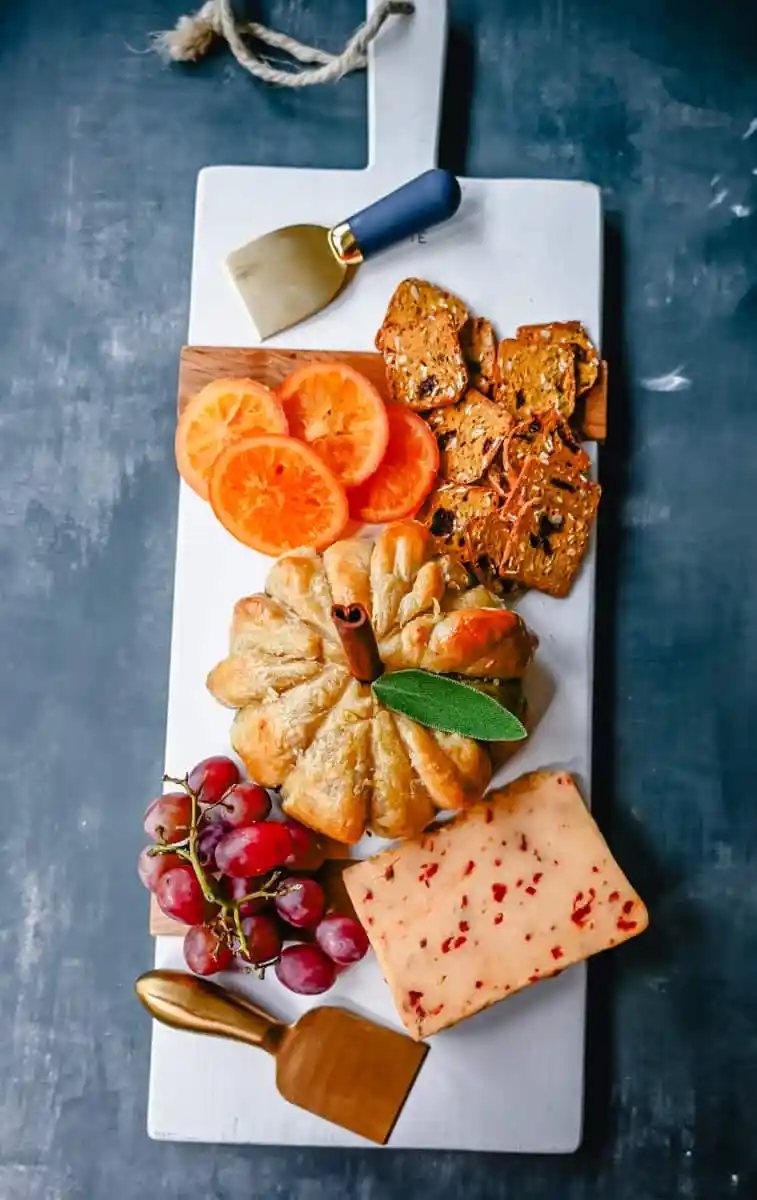 Pumpkin Shaped Baked Brie Puff Pastry. This festive Fall Pumpkin Baked Brie is the perfect appetizer or centerpiece for your charcuterie board. Flaky puff pastry baked with creamy brie cheese and pumpkin butter or fig jam is the perfect salty sweet combination.