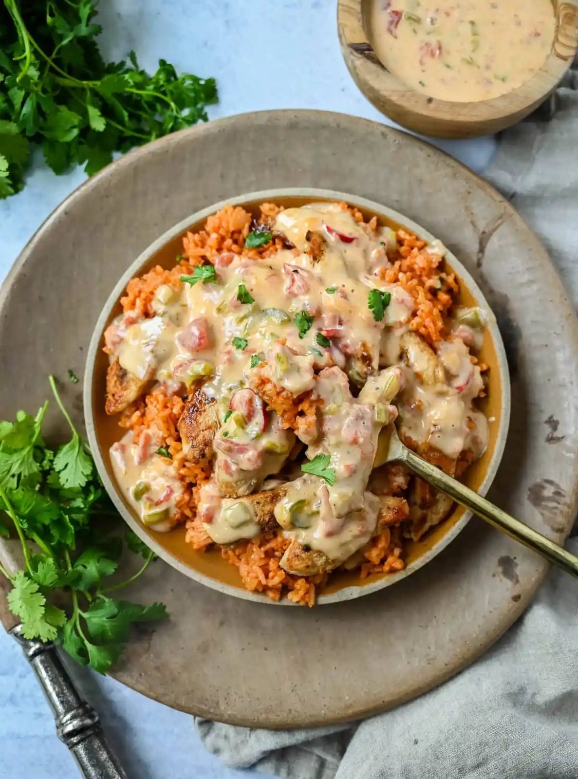 This Queso Smothered Chicken is a comforting, flavor-packed meal that makes everyone at the table ask for seconds — Pollo con Queso is it. This dish brings together juicy sautéed chicken, homemade Spanish rice, and a rich, creamy queso sauce made from scratch. A hearty, cheesy, restaurant-style dish you can make right at home — and better than takeout.